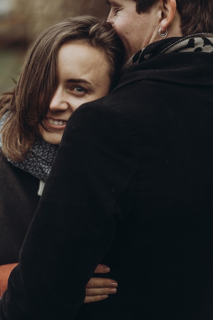 Stylish man and woman hugging romantic calm atmospheric moment couple embracing gently in autumn park showing true feelings family togetherness concept