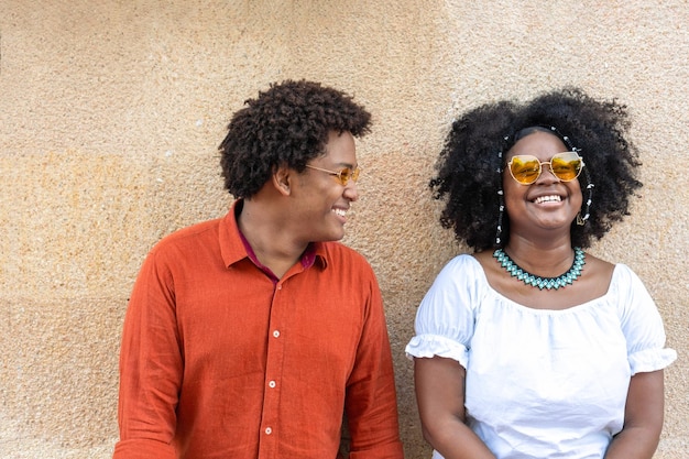 Stylish multiracial people standing in the city and laughing together