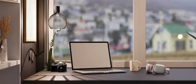 Stylish office workspace with laptop mockup headphone and decor on black table against the window