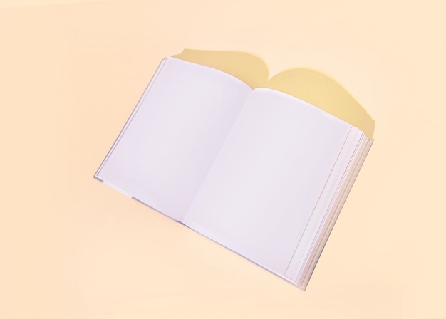 Stylish opened  book on a colored yellow peach background