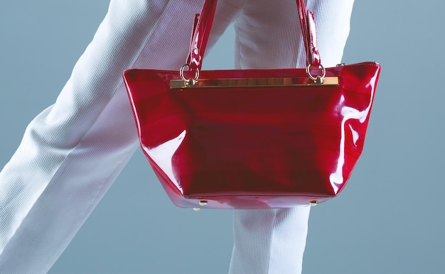 Stylish red patent leather bag on a blue background