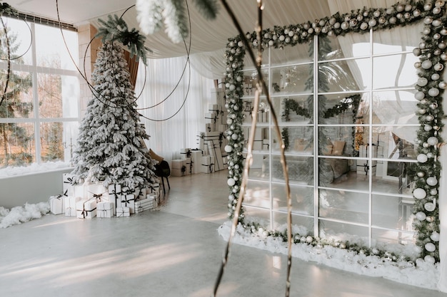 Stylish room interior with beautiful Christmas tree and decorative fireplace