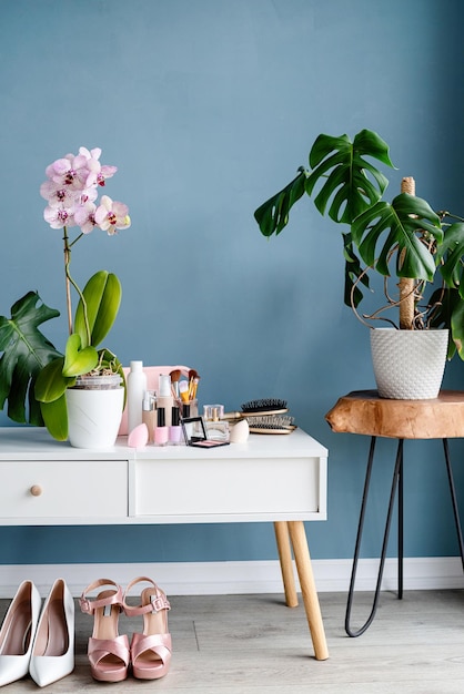 Stylish room interior with elegant dressing table and plants