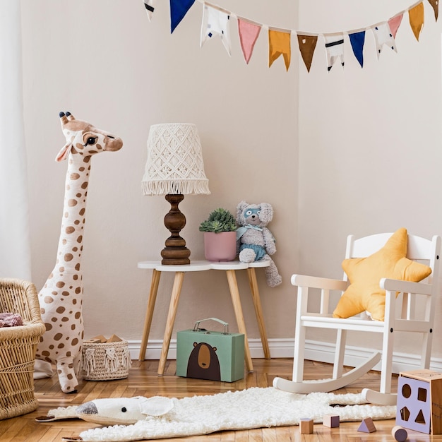 Stylish scandinavian interior of child room with mock up frame ,natural toys, hanging decoration, design furniture, plush animals, teddy bears and accessories. Interior design of kid room. Template.