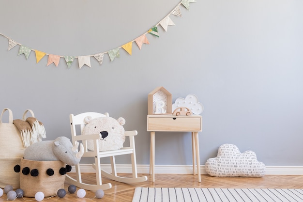 Stylish scandinavian kid room with copy space, toys, teddy bear, plush animal and children accessories