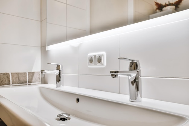 Stylish sink with two taps with illuminated mirror