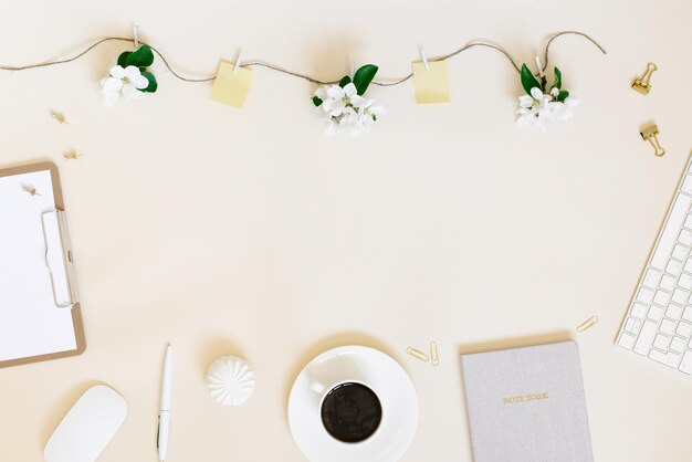 Stylish stationery on a beige background Flat lay top view The concept of a freelancer's workspace in spring