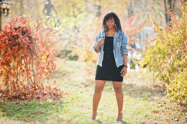 Stylish trendy afro france curly woman posed at autumn day in jeans jacket. Black african female model.