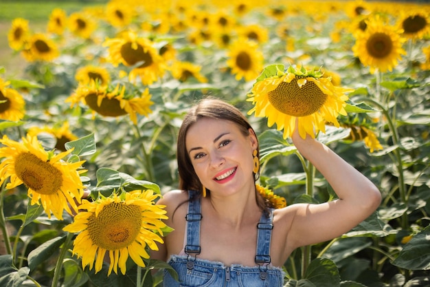 Stylish Ukrainian young girl in a field with sunflowers