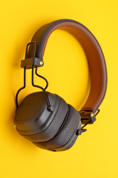 Stylish wireless headphones in a classic style on a yellow background