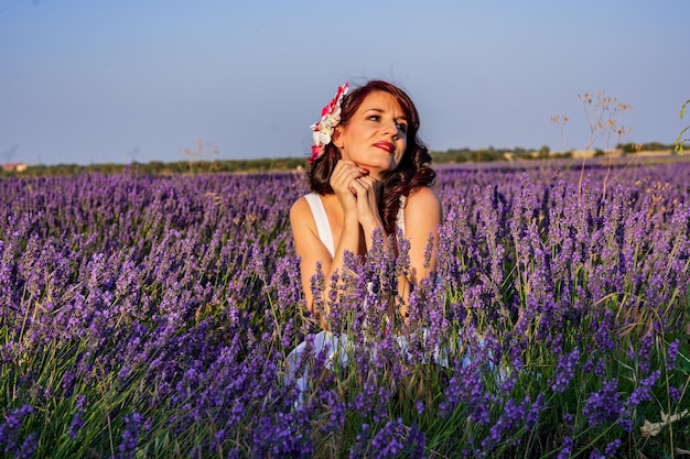 Stylish woman looking away while posing outdoors in a colourful lavender field