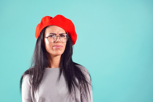 Stylish woman in red beret frowned at camera