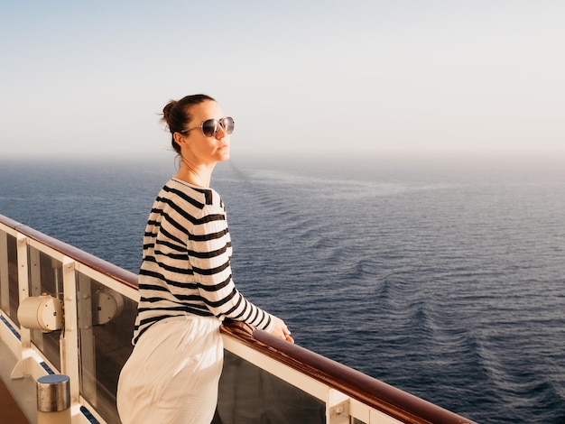 Stylish woman standing on the empty deck