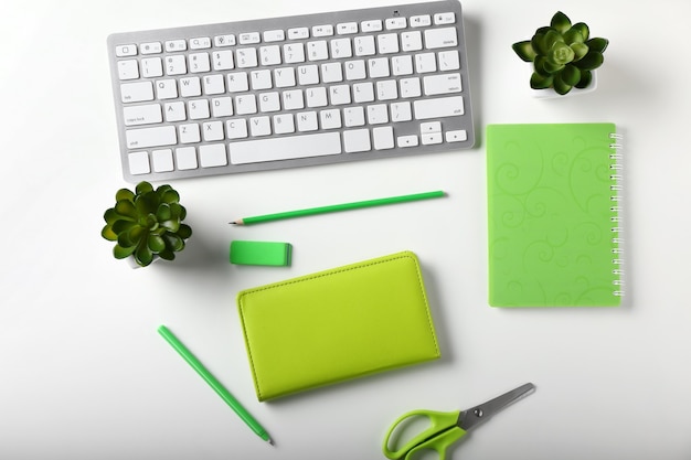 Stylish workplace with computer keyboard and stationery