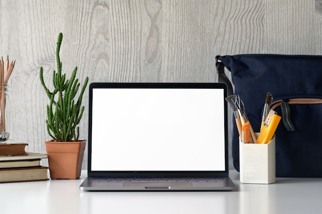 Stylish workspace with mockup laptop on desk table.