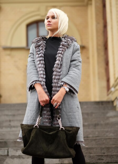 Stylish young blond woman wearing a winter look