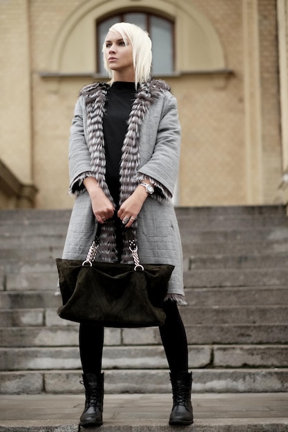 Stylish young blond woman wearing a winter look