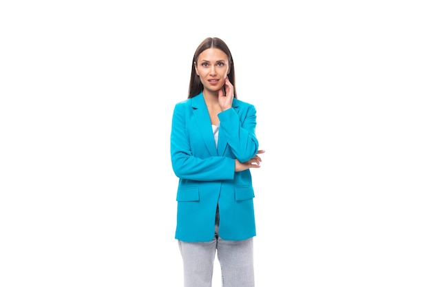 Stylish young brunette businesswoman in blue jacket isolated on white background with copy space