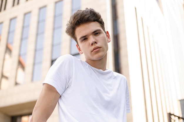 Stylish young man posing with a fashionable white t-shirt