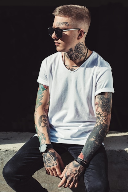 Stylish young man with tattoos