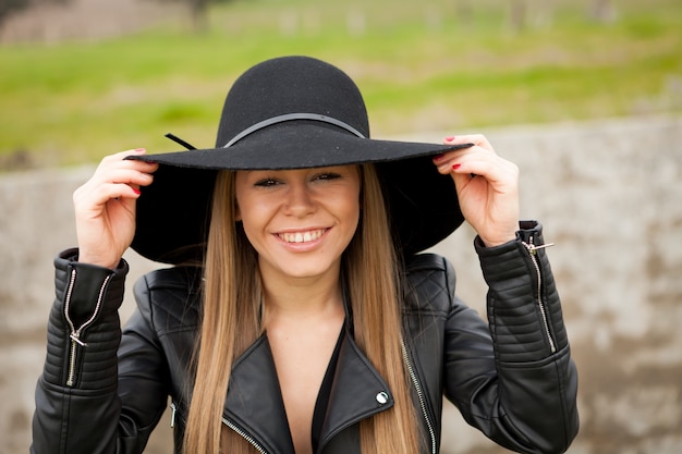 Stylish young woman with beautiful hat 