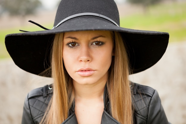 Stylish young woman with beautiful hat 