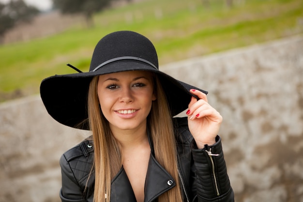 Stylish young woman with beautiful hat 