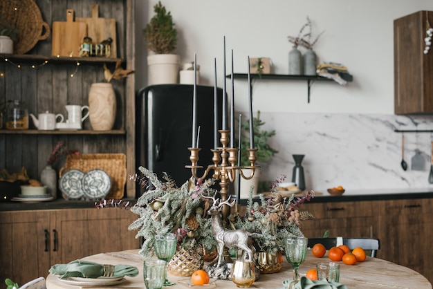 Stylishly decorated festive dining table for Christmas in the kitchen