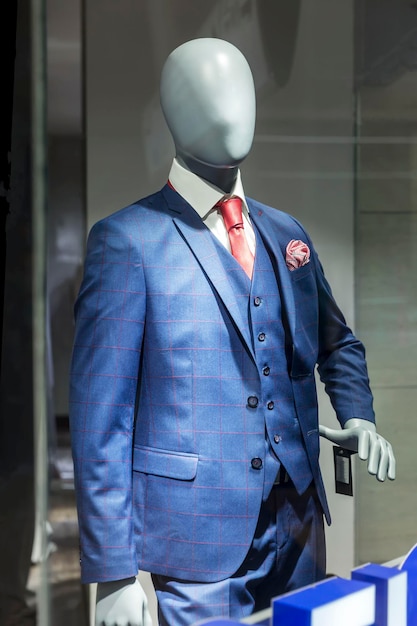 Stylishly dressed mannequin in the window of a clothing store in a shopping mall New fashion collection Closeup Vertical