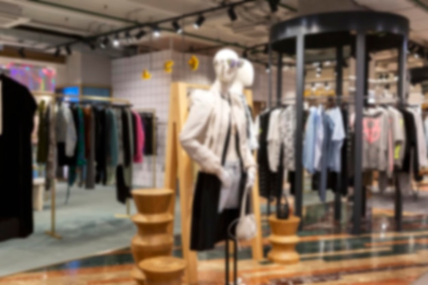 Stylishly dressed mannequins in a fashion boutique Springsummer collection Blurred