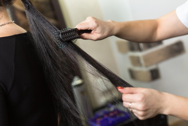 Stylist working with client in salon closeup