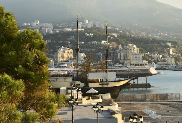 stylized vintage ships for fun on the yalta waterfront early in the morning in pink light