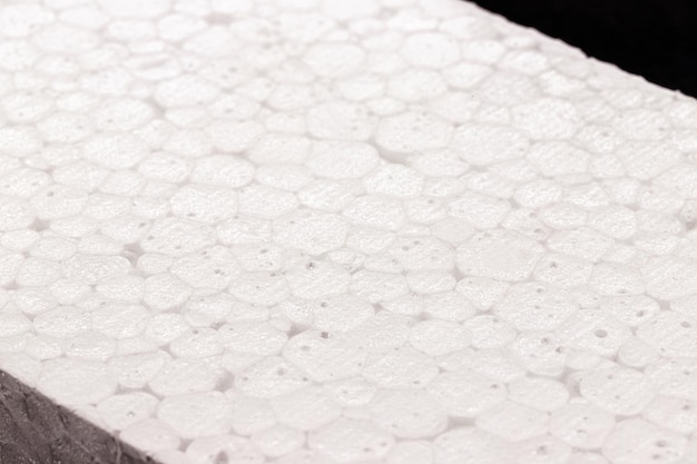 Styrofoam board isolated on black background nontoxic polystyrene material thermoplastic and flexible resin used in the transport construction and food preservation industry