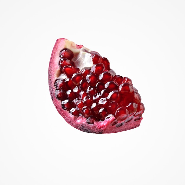 Subtropic fruit composition. Delicious colorful red piece pomergranate isolat on blank studio background.