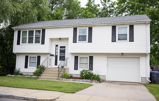 suburban house engulfed in a rising dollar sign symbolizes the meaning and symbolism of mortgagedri