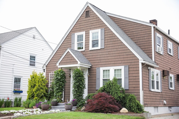 suburban house engulfed in a rising dollar sign symbolizes the meaning and symbolism of mortgagedri