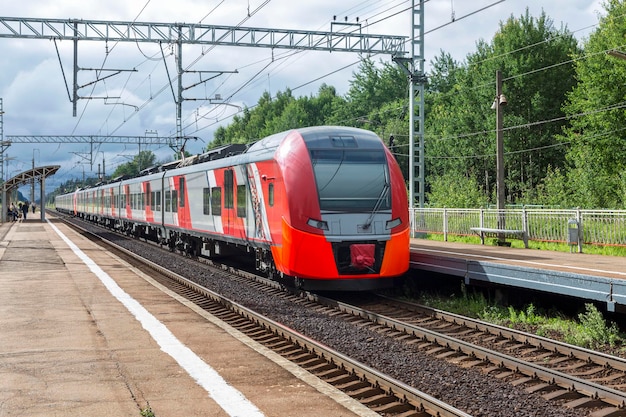 Suburban modern electric train stands at a rural station Travel and tourism