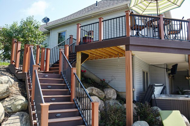 Suburban Wooden Deck with Outdoor Furniture and Plants Low Angle View