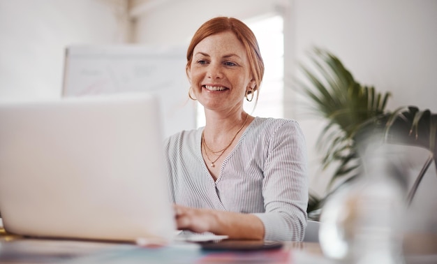 Success belongs to the hard working Shot of a mature businesswoman working on a laptop in an office