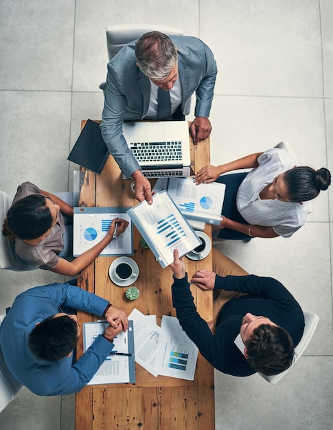 Success is on the top of their agenda High angle shot of a group of businesspeople having a meeting in an office