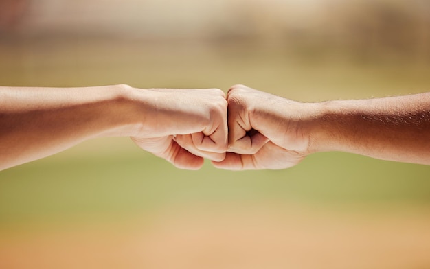 Success support and hands giving fist bump for motivation celebration and teamwork in goal outdoor in nature Zoom in of people show agreement growth and connection with community or partnership