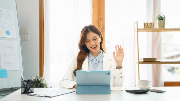 Successful business concept Businesswoman doing greeting gesture with colleague on video call