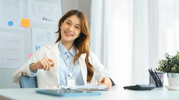 Successful business concept Businesswoman look on camera to smiling while sit to working in office