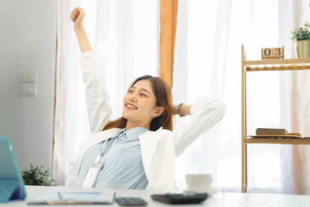 Successful business concept Businesswoman raising arm to stretching after hard working new project