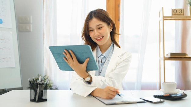 Successful business concept Businesswoman read financial report on tablet to checking on document