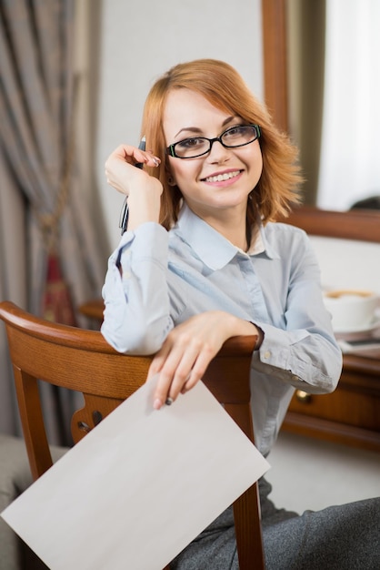 Successful business lady working with laptop in hotel room on business trip