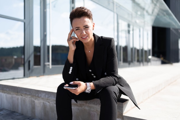 Successful business owner posing of office building