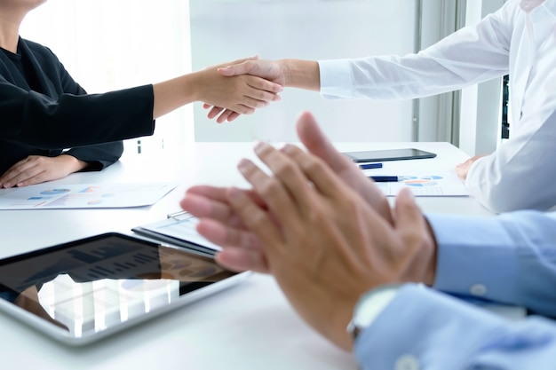 Successful business team clapping after good deal.