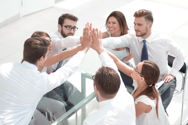 Successful business team giving each other a high fivethe concept of unanimity