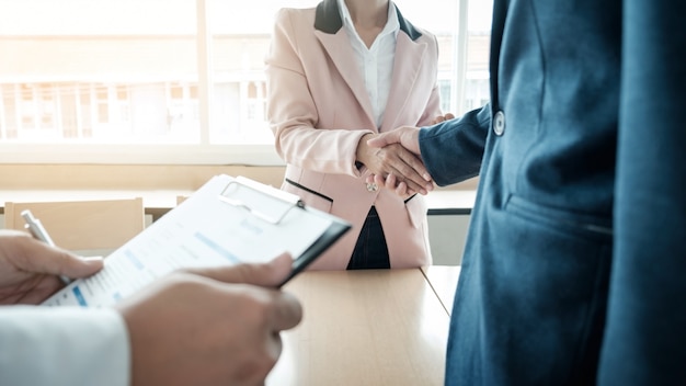 of successful business team shaking hands with eachother in the office, job interview concept